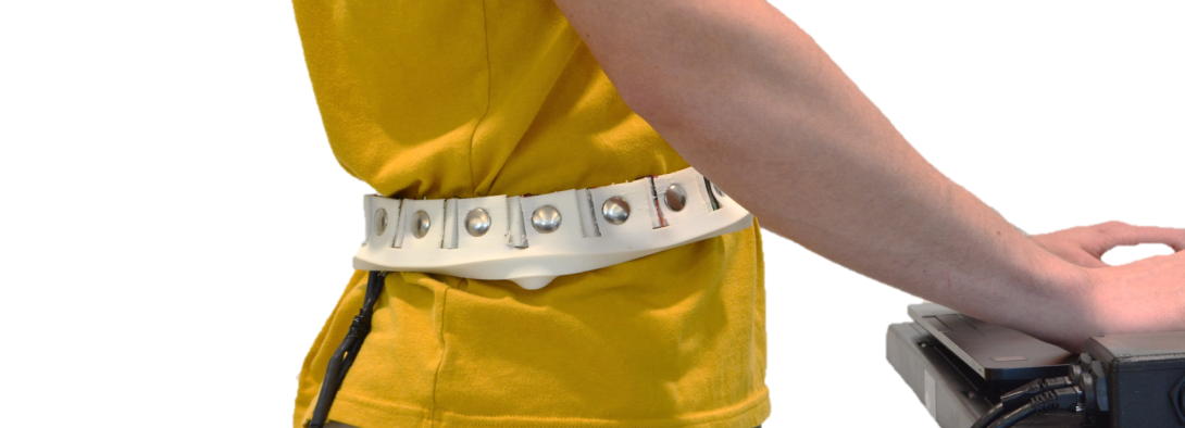 a participant is wearing a 3d printed vibrotactile waistband while performing a task on a computer